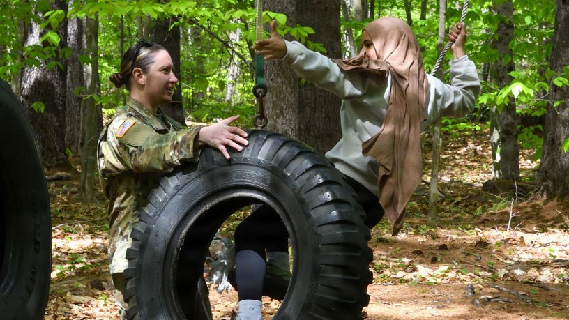 Sgt. Elizabeth Karkos of the Maine National Guard's Counterdrug Task Force helps an Auburn Middle School student navigate a confidence course at the Bog Brook Training Site in Gilead on May 21, 2026.