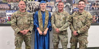 Sgt. 1st Class Ian Walker, Pvt. Logan May, Staff Sgt. Kolten Conant and Spc. Dustyn Sneider pose for a photo on May 22, 2026, at Midvale High School in Midvale, Idaho. Just five days before, May suffered a cardiac arrest during a fitness training event and Walker, Conant and Sneider worked together to revive May, which likely saved his life. Conant recruited May into the Idaho Army National Guard in April.