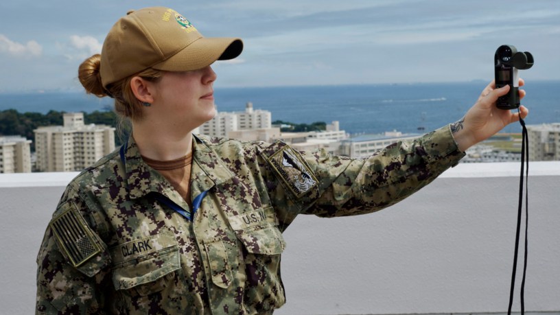 Navy Seaman Sara Clark, assigned to the Naval Oceanography Antisubmarine Warfare Center, Yokosuka, Japan, demonstrates the Kestrel while standing on top of the command's local headquarters building, May 27, 2026.