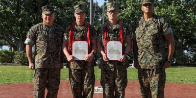 U.S. Marine Corps Lance Cpl. Austin Cusson, a logistics specialist with Headquarters Battalion, 2nd Marine Division, and Lance Cpl. Andrew Cusson, an ammunition technician with 2nd Light Armored Reconnaissance, 2nd MARDIV, pose for a photo with 2nd MARDIV command leadership after a promotion ceremony on Marine Corps Base Camp Lejeune, June 2, 2026.