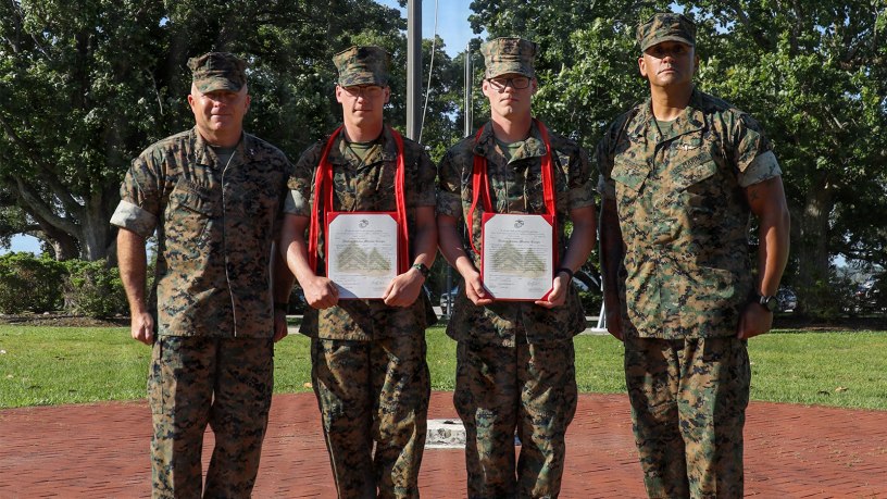 U.S. Marine Corps Lance Cpl. Austin Cusson, a logistics specialist with Headquarters Battalion, 2nd Marine Division, and Lance Cpl. Andrew Cusson, an ammunition technician with 2nd Light Armored Reconnaissance, 2nd MARDIV, pose for a photo with 2nd MARDIV command leadership after a promotion ceremony on Marine Corps Base Camp Lejeune, June 2, 2026.