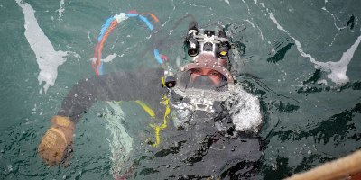 U.S. Navy CM2 Tyler Huntoon, assigned to Construction Dive Detachment 2-4, Underwater Construction Team TWO, returns to the surface following underwater operations in support of P-209, the future Dry Dock 5, at Pearl Harbor Naval Shipyard, Hawaii, June 2, 2026. (U.S. Navy photo by Jhewel Felipe)