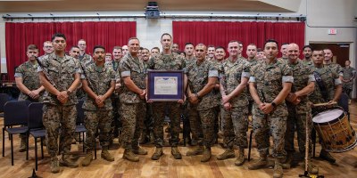U.S. Marine Corps Lt. Gen. Leonard F. Anderson IV, commander of Marine Forces Reserve and Marine Forces South, and Sgt. Maj. Edwin A. Mota, command senior enlisted advisor of Marine Forces Reserve and Marine Forces South, pose for a photo with the Marine Forces Reserve Band during a ceremony at Marine Forces Support Facility New Orleans, June 4, 2026.