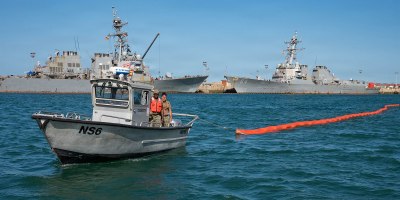 A harbor patrol boat maneuvers oil containment buoys during a bilateral oil spill response exercise with the Spanish Armada onboard Naval Station (NAVSTA) Rota, Spain, June 4, 2026.