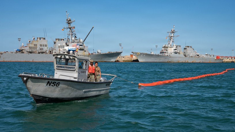 A harbor patrol boat maneuvers oil containment buoys during a bilateral oil spill response exercise with the Spanish Armada onboard Naval Station (NAVSTA) Rota, Spain, June 4, 2026.