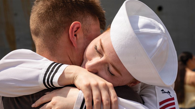 U.S. Navy Damage Controlman Fireman Emma Tripp greets her partner following a 10-month deployment as part of the Iwo Jima Amphibious Ready Group (IWO ARG).