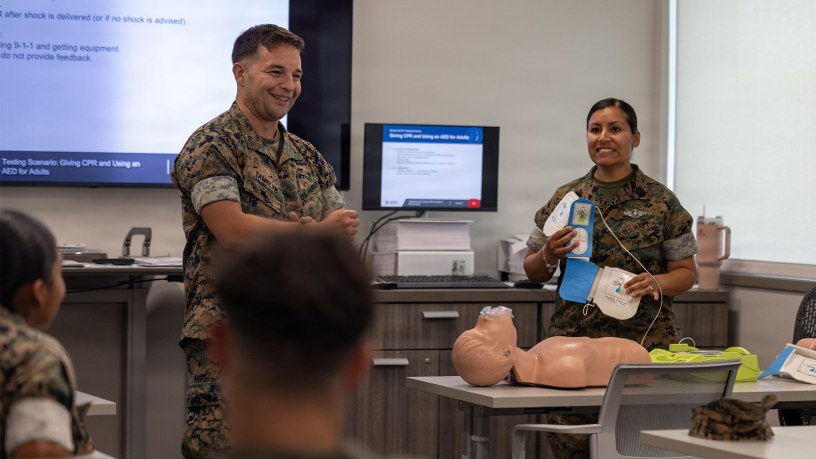 U.S. Marine Corps Capt. Sebastian Tamblyn, left, shelter officer in charge, Marine Corps Air Station New River, and U.S. Navy Petty Officer 1st Class Roxana Q. Lacey, field medical technician, Marine Medium Tiltrotor Squadron 264, Marine Aircraft Group 26, 2nd Marine Aircraft Wing, give a demonstration during a cardiopulmonary resuscitation class at the Marine Corps Medical Home New River at MCAS New River, North Carolina, June 8, 2026.