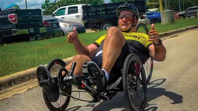 Retired Master Sgt. Christopher Morago, a Team Army competitor, gives two thumbs up while riding a recumbent bike during practice ahead of the 2026 Warrior Games in San Antonio, Texas, June 10, 2026.