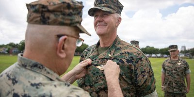 U.S. Navy Rdml. Anthony Lacourse, reserve medical officer, Marine Forces Reserve, pins Fleet Marine Force insignia on Lt. Cmdr David Westenberg, dentist, 4th Dental Battalion, during a Fleet Marine Force (FMF) pinning ceremony at Marine Forces Reserve, June 11, 2026.