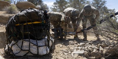 Utah National Guard Soldiers assigned to the 19th Special Forces Group (Airborne), attach a cargo net holding dinosaur bones to a UH-60 Black Hawk during an air lift in southern Utah, June 13, 2026.