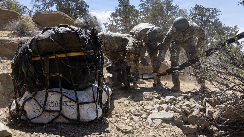Utah National Guard Soldiers assigned to the 19th Special Forces Group (Airborne), attach a cargo net holding dinosaur bones to a UH-60 Black Hawk during an air lift in southern Utah, June 13, 2026.