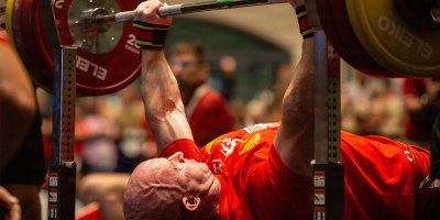 U.S. Marine Corps Master Sgt. Stevan Ball, an Idaho native and communications chief with Wounded Warrior Regiment, prepares to bench press as family members, friends and service members cheer him on during the powerlifting event at the 2026 Warrior Games at the Henry B. González Convention Center in San Antonio, Texas, June 13, 2026.
