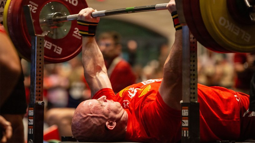 U.S. Marine Corps Master Sgt. Stevan Ball, an Idaho native and communications chief with Wounded Warrior Regiment, prepares to bench press as family members, friends and service members cheer him on during the powerlifting event at the 2026 Warrior Games at the Henry B. González Convention Center in San Antonio, Texas, June 13, 2026.