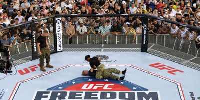 U.S. Army Sgt. 1st Class Anais A. Moise and U.S. Navy Lt. Margaret B. Peacher demonstrate combatives techniques inside the octagon during UFC Freedom 250 events at the Ellipse in Washington, D.C., June 14, 2026. The demonstration showcased hand-to-hand combat skills, physical readiness, and joint service participation in front of attendees gathered near the Washington Monument. (U.S. Army photo by Sgt. 1st Class Brittany Primavera)