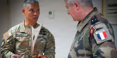 Maj. Gen. Lance Okamura, deputy commanding general of U.S. Army Pacific–Homeland Affairs, presents a traditional Hawaiian voyaging canoe to Rear Adm. Guillaume Pinget, commander of the French Armed Forces in French Polynesia, during a gift exchange following a distinguished visitor day for Exercise MARARA 26 in Tahiti, French Polynesia, June 16, 2026.