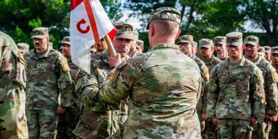 1st Sgt. Asa Esslinger passes the Charlie Company, 2nd Battalion, 116th Cavalry Regiment guidon to a soldier during the company's change of command ceremony of Charlie Company, 2nd Battalion, 116th Cavalry Regiment, June 18, 2026, at Gowen Field, Boise, Idaho.