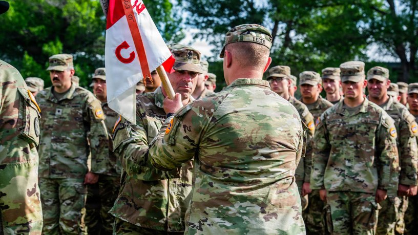 1st Sgt. Asa Esslinger passes the Charlie Company, 2nd Battalion, 116th Cavalry Regiment guidon to a soldier during the company's change of command ceremony of Charlie Company, 2nd Battalion, 116th Cavalry Regiment, June 18, 2026, at Gowen Field, Boise, Idaho.