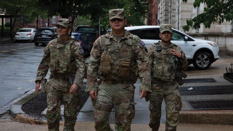 From left to right, U.S. Army Pfc. Gabriel Oliva, Sgt. Memphis Perez, and Spc. Edwin Martinez, all with the Arkansas National Guard assigned to Joint Task Force-District of Columbia in support of the DC Safe and Beautiful, mission patrol near Thomas Circle in Washington, June 23, 2026.
