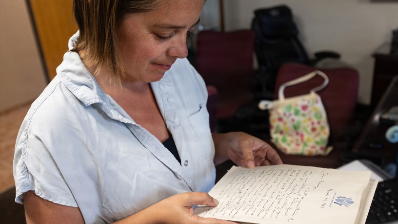 Kelli Mitchell, Fort Knox’s historical preservation specialist at the Cultural Resources Office, reads one of many letters penned by George Edick to his then-fiancé Nancy Budd. The trove of letters was recently donated by George and Nancy’s two sons, Geoff and Jim. They donated the letters to Fort Knox since they depict life at the installation prior to World War II.