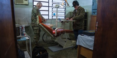 Paraguayan dental equipment specialist Juan Alfonso, right, and U.S. Air Force Master Sgt. Russell Hires, biomedical equipment technician, inspect a repaired dental chair during Amistad 2026 in Capiatá, Paraguay, June 24, 2026.