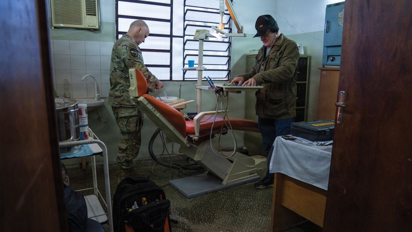 Paraguayan dental equipment specialist Juan Alfonso, right, and U.S. Air Force Master Sgt. Russell Hires, biomedical equipment technician, inspect a repaired dental chair during Amistad 2026 in Capiatá, Paraguay, June 24, 2026.