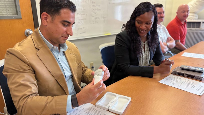 Munson Army Health Center Senior Enlisted Advisor Sgt. Maj. Jason Trevino examines a wireless ultrasound device used by participants in The University of Kansas Health System Military Training Program, June 24.