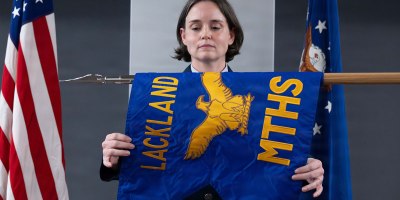 U.S. Air Force Col. Shawn Garcia, commander of the Lackland Medical Group, unfurls the newly activated Lackland Mental Health Squadron guidon during an activation ceremony at Wilford Hall Ambulatory Surgical Center, Joint Base San Antonio-Lackland, Texas, June 25, 2026.