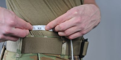 An Airman of the 185th Air Refueling Wing measures his waist at the 185th Air Refueling Wing in Sioux City, Iowa, Jan. 11, 2024.