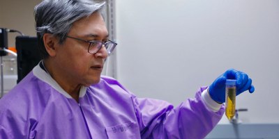 Dr. Biswajit Biswas, chief of Bacteriophage Science Division with Naval Medical Research Command (NMRC), inspects a purified phage sample as part of bacteriophage therapy research to combat multidrug resistant bacteria that could impact warfighter readiness.