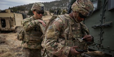 Pfc. Laurence Smith (right) and Spc. Andrew Hwang, electromagnetic warfare specialists, both assigned to 4th Squadron, 10th Cavalry Regiment, 3rd Armored Brigade Combat Team, 4th Infantry Division, don the Beast+ system during Ivy Sting 4 on Fort Carson, Colorado, Feb. 2, 2026.