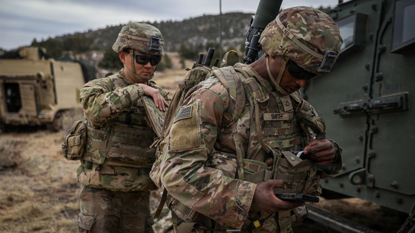Pfc. Laurence Smith (right) and Spc. Andrew Hwang, electromagnetic warfare specialists, both assigned to 4th Squadron, 10th Cavalry Regiment, 3rd Armored Brigade Combat Team, 4th Infantry Division, don the Beast+ system during Ivy Sting 4 on Fort Carson, Colorado, Feb. 2, 2026.