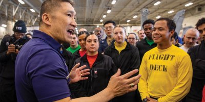 The Honorable Hung Cao, Acting Secretary of the Navy, left, speaks to Sailors in the hangar bay of the world’s largest aircraft carrier, USS Gerald R. Ford (CVN 78), while underway in the Mediterranean Sea, May 4, 2026.