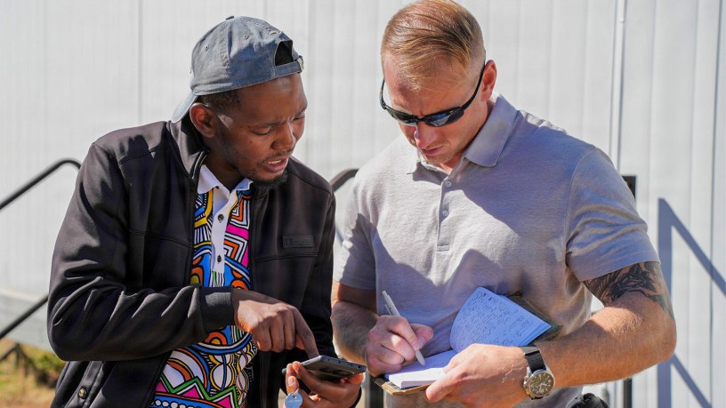 U.S. Army Master Sgt. Joseph Buth, right, team sergeant assigned to Civil Affairs Team Botswana, Bravo Company, Civil Affairs Battalion, U.S. Army Southern European Task Force, Africa (SETAF-AF), exchanges contact information after conducting an assessment of prefabricated clinics with Malefo Kgosimore, left, administrative officer-accountant at Bobonong Primary Hospital, in Bobonong, Botswana, May 9, 2026.