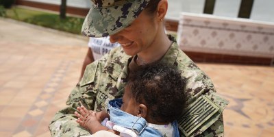 Lt. Kathleen Carter, a labor and delivery nurse working in the multiservice ward at U.S. Naval Hospital Rota, holds baby Keilah during a reunion in Rota, Spain, June 1, 2026.