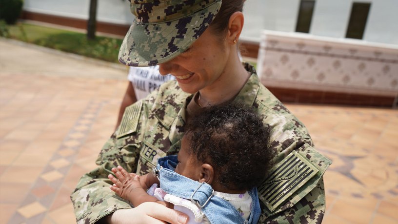 Lt. Kathleen Carter, a labor and delivery nurse working in the multiservice ward at U.S. Naval Hospital Rota, holds baby Keilah during a reunion in Rota, Spain, June 1, 2026.
