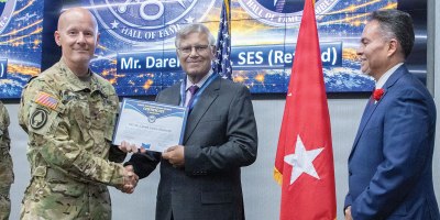 Maj. Gen. Timothy D. Brown, then-commanding general, U.S. Army Intelligence and Security Command (INSCOM), and George "Angel" Lopez, Jr. (right), INSCOM G3 Aerial Intelligence, Surveillance and Reconnaissance (A-ISR) director, pose with Darell Lance, Defense Intelligence Senior Executive Service (Ret.), U.S. Army Col. (Ret.), and former INSCOM chief of staff.