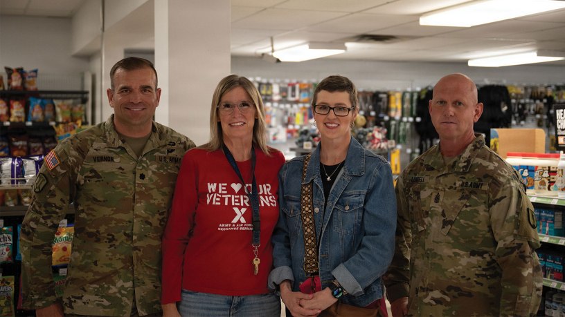 Lt. Col. Christopher Vernon, Jenn Withers, Heather Felt, and Command Sgt. Maj. Jed Lundell gather for a group photo to commemorate the recognition of a life saving action. June 6th 2026, Camp Williams Troop Store.