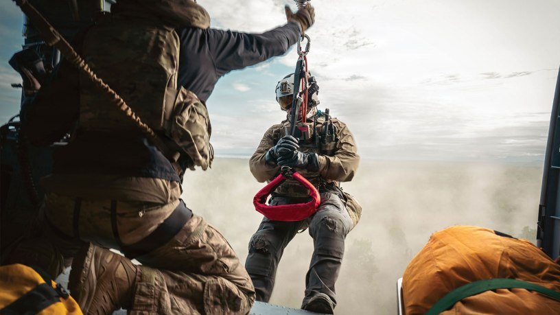 U.S. Air Force Master Sgt. Allenmikel Armstrong, 212th Rescue Squadron pararescueman, hoists from a HH-60W Jolly Green II during the Arctic Thunder Open House 26 full-scale exercise on Joint Base Elmendorf-Richardson, Alaska, June 17, 2026.