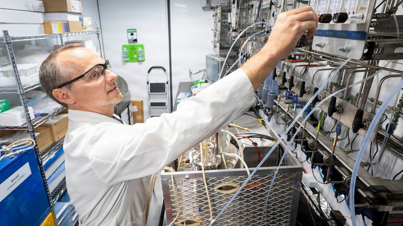 Matthew Yates, Ph.D., U.S. Naval Research Laboratory research scientist, adjusts the flow rate of gas for material generation in the mobile biomanufacturing system in Washington, D.C., June 23, 2026.