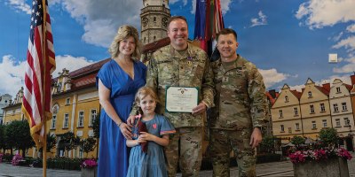 U.S. Army Col. Michael Filanowski, deputy chief of staff for operations for Multinational Division North East, NATO, stands for a picture with his family and U.S. Army Maj. Gen. John Lubas, commanding general of the 3rd Infantry Division, after receiving the Purple Heart on June 25, 2026, in Boleslawiec, Poland.