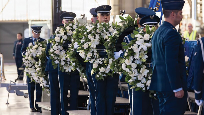 Senior Airman Christian Yokotake and fellow Airmen of the Blue Eagles Honor Guard, on behalf of “Torch 11” family members, prepare to attach wreaths to easels holding the images of the fallen B-52 aircrew.