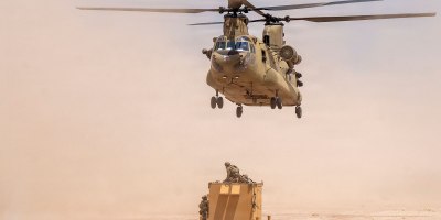 A U.S. Army CH-47 Chinook helicopter with the Combat Aviation Brigade, 1st Armored Division, assigned to Joint Task Force-Southern Border, hovers over a telecommunication network system during a sling load mission as part of Operation Muleskinner Trailblazer III in Big Bend, Texas, June 30, 2026.