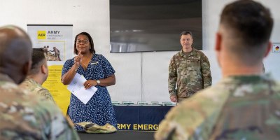 Briana Johnson, the Wiesbaden garrison's AER officer, stands together with Wiesbaden Garrison Commander Col. Ringo Midles, in front of Soldiers during the awards ceremony on July 1, 2026, to recognize top representatives and units for their Army Emergency Relief efforts.