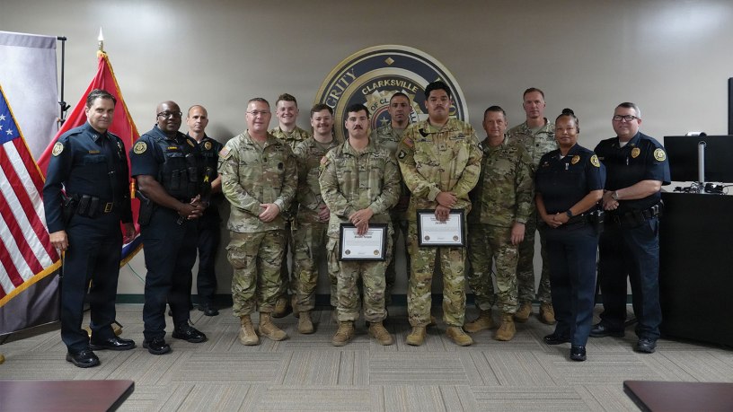 Clarksville Police Chief Ty Burdine, U.S. Army Sgt. Jacob Paz, and Sgt. Maisen Temple, pose for a group photo with officers from the Clarksville Police Department and leadership from the 101st Combat Aviation Brigade at the Clarksville Police Department Headquarters, June 24, 2026.