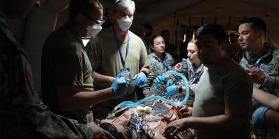 U.S. Air Force and Chilean air force medical service members perform a mock operation for an injured service member for a mass casualty training during Exercise Salitre 2026 at Cerro Moreno Air Base in Antofagasta, Chile, July 7, 2026.