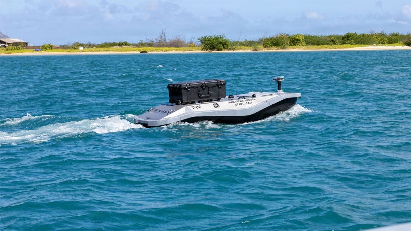 A digitally crewed surface vessel heads out to sea from Sand Island near Honolulu, Hawaii, to deliver parts for a 3D printer aboard Wasp-class amphibious assault ship USS Essex (LHD-2) during Exercise Rim of the Pacific 2026, July 7, 2026.