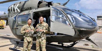 U.S. Army 2nd Lts. Kyler Suerth, left, and Blaine Dolin, student pilots assigned to the 1st Battalion, 145th Aviation Regiment, stand outside of their LUH-72 Lakota helicopter after the completion of their first solo cross country flight at Shell Army Heliport, at Fort Rucker, on July 16, 2026.