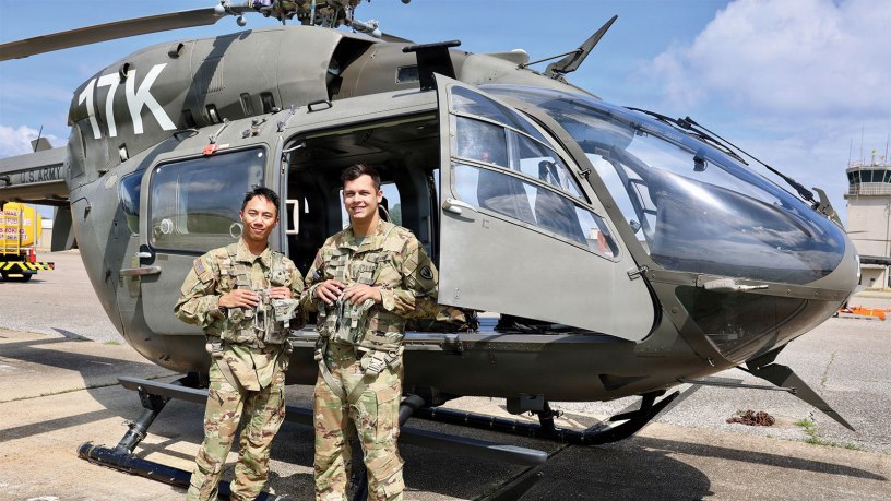 U.S. Army 2nd Lts. Kyler Suerth, left, and Blaine Dolin, student pilots assigned to the 1st Battalion, 145th Aviation Regiment, stand outside of their LUH-72 Lakota helicopter after the completion of their first solo cross country flight at Shell Army Heliport, at Fort Rucker, on July 16, 2026.