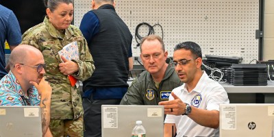 U.S. Air Force Staff Sgt. Marwan AlSaeedi, 439th Communications Squadron client services technician, explains the cyber assessments he conducted to Col. Christopher Holland, 439th Airlift Wing commander, and Chief Master Sgt. Kristen M. Maloney, 439th Airlift Wing command chief at the Cyber Chicopee Innovative Readiness Training program in Chicopee, Mass., July 21, 2026.