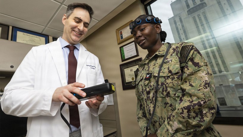 U.S. Army Maj. Zachary S. Davey, a neurologist at Walter Reed National Military Medical Center, reviews data from a point-of-care EEG system with U.S. Navy Hospital Corpsman 3rd Class Tulisa Reeves during a technology demonstration, Bethesda, Md., July 8, 2026.